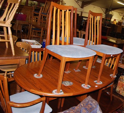 Lot 1273 - A 1980s G-Plan teak dining suite comprising; D-...
