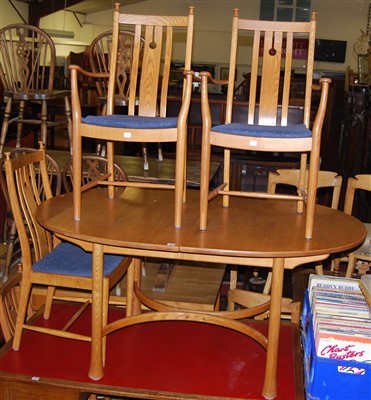 Lot 1298 - A contemporary Ercol blond elm dining suite...
