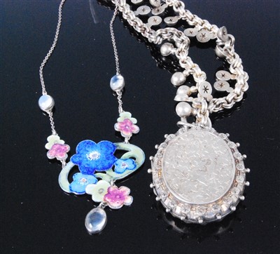 Lot 410 - A silver and engraved picture locket on chain...