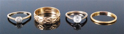 Lot 425 - A 9ct gold and engraved wedding band together...