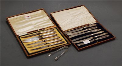 Lot 329 - A pair of modern silver sugar bows; together...