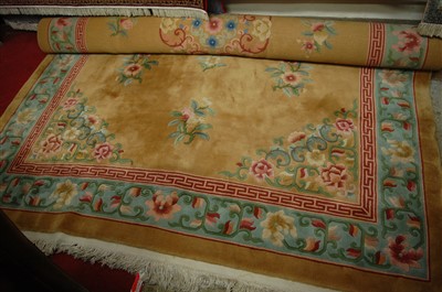Lot 1146 - A Chinese Superwash carpet, the beige ground...