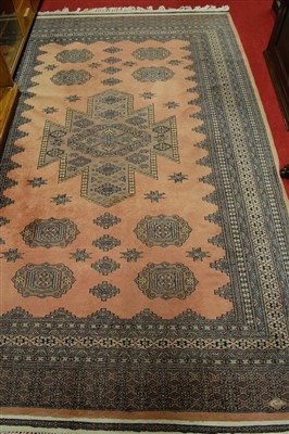 Lot 1136 - A Persian woollen pink ground Bokhara rug,...