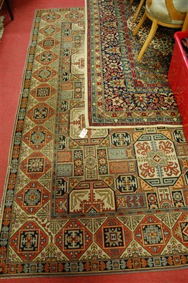 Lot 1135 - A Persian style machine-woven woollen carpet;...