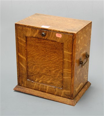 Lot 597 - An Edwardian oak stationery cabinet, the fall...