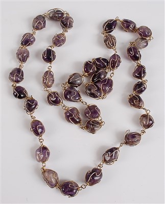Lot 2521 - An opera length amethyst necklace, featuring...