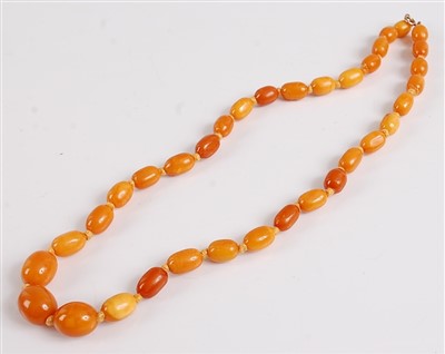 Lot 2531 - A single row amber necklace, consisting of 35...