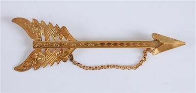 Lot 2547 - A yellow metal engraved bar brooch in the form...