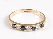 Lot 2569 - A yellow metal, sapphire and diamond claw set...