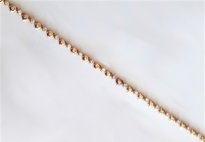 Lot 1209 - A yellow metal diamond necklet, having...