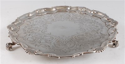 Lot 1079 - A George II silver salver, having floral and C-...