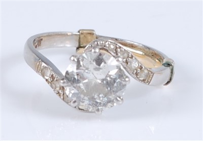 Lot 1230 - A white metal single stone diamond crossover...