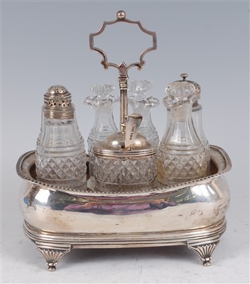 Lot 1141 - A George III silver seven bottle cruet stand,...