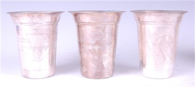 Lot 1318 - A set of three Indian silver goblets, each...