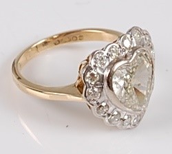 Lot 1226 - An 18ct yellow and white gold heart shaped...