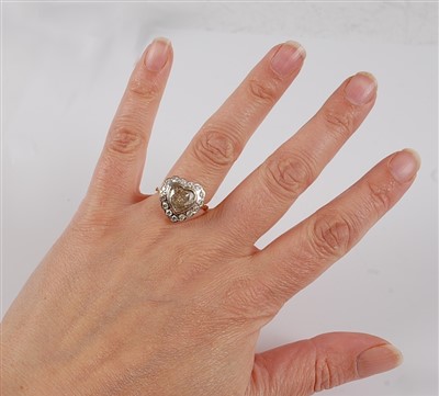 Lot 1226 - An 18ct yellow and white gold heart shaped...