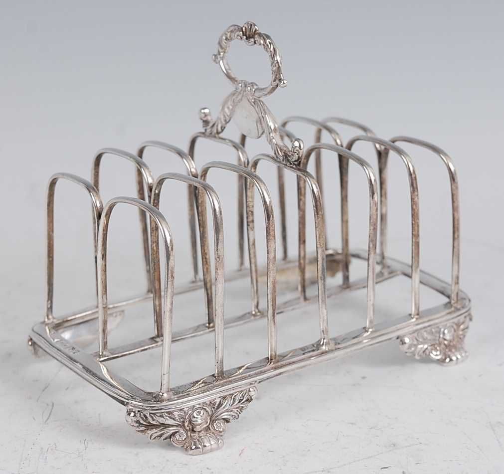 Lot 1107 - A George IV silver six division toast rack,...