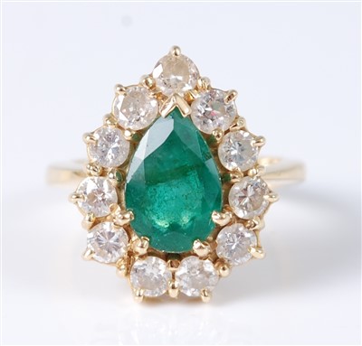 Lot 1225 - An 18ct yellow gold pear shaped emerald and...
