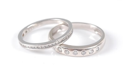 Lot 2629 - An 18ct white gold diamond set band ring, with...