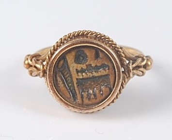 Lot 2641 - A yellow metal circular signet ring, the ring...