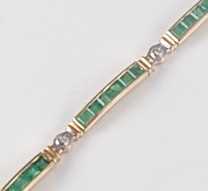 Lot 2646 - A yellow metal, emerald and diamond line...