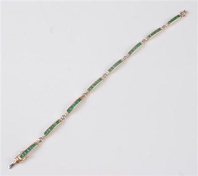 Lot 2646 - A yellow metal, emerald and diamond line...