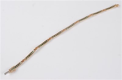 Lot 2646 - A yellow metal, emerald and diamond line...