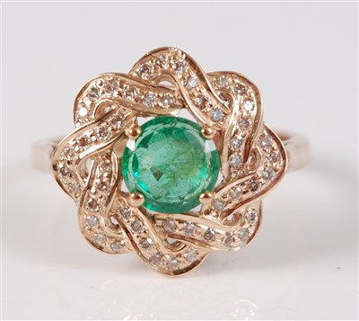 Lot 2659 - A yellow metal, emerald and diamond circular...