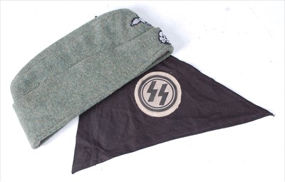 Lot 141 - A German side cap with modern SS badges,...