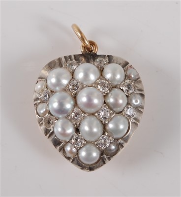 Lot 2752 - A yellow and white metal heart shaped pendant,...