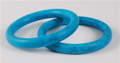 Lot 2761 - A pair of solid turquoise bangles, each...