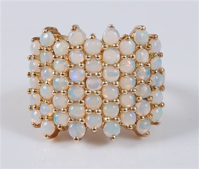 Lot 2765 - A modern yellow metal and opal set dress ring,...