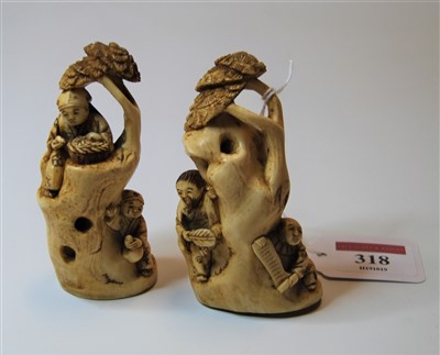 Lot 318 - A pair of Japanese okimono, each carved as two...