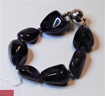 Lot 324 - A ladies amethyst bracelet having seven...