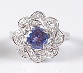 Lot 2180 - A white metal, tanzanite and diamond circular...