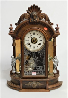 Lot 18 - A late 19th century walnut cased mantel clock,...