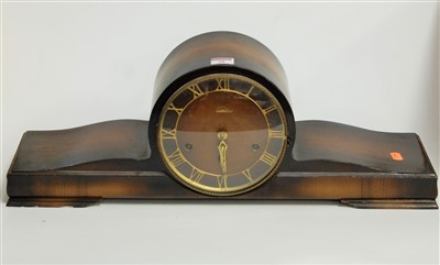 Lot 38 - A 1950s beech cased mantel clock, the brass...