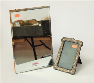 Lot 65 - A silver clad easel photograph frame, in the...