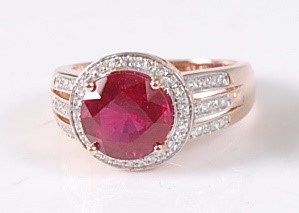 Lot 2178 - A rose gold, ruby and diamond circular cluster...