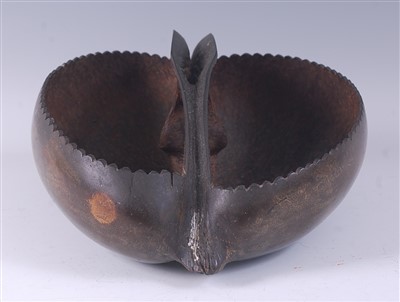 Lot 2254 - A coco de mer nut pod, cut away and carved to...