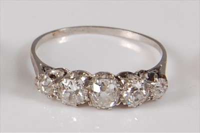 Lot 2226 - A white metal diamond five-stone half hoop...