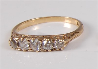 Lot 1201 - An early 20th century yellow metal five stone...