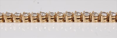 Lot 2207 - An 18ct yellow gold diamond tennis bracelet,...