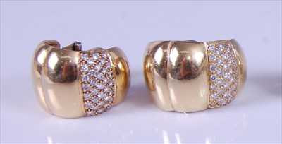 Lot 2144 - A pair of yellow metal diamond set half hoop...