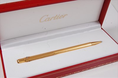 Lot 2290 - A Must de Cartier gilt metal stylo pen, the...