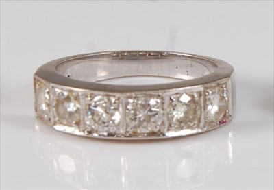 Lot 2282 - A white metal diamond half hoop eternity ring,...