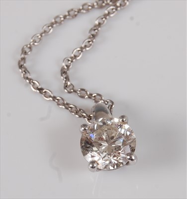Lot 2228 - A platinum set diamond pendant, the round cut...