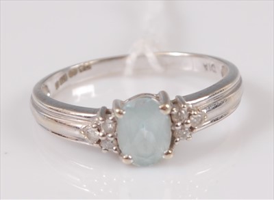 Lot 306 - A modern 9ct white gold blue topaz dress ring...