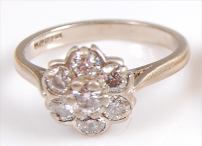 Lot 2025 - An 18ct white gold diamond circular cluster...