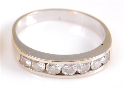 Lot 2027 - A yellow metal diamond seven stone half hoop...